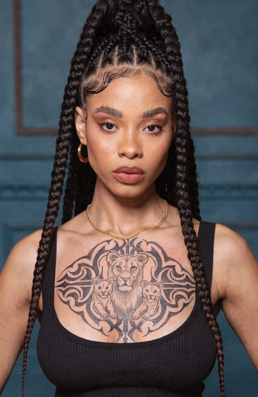 Black ink chest tattoo of mama lion with two cubs in symmetrical tribal frame