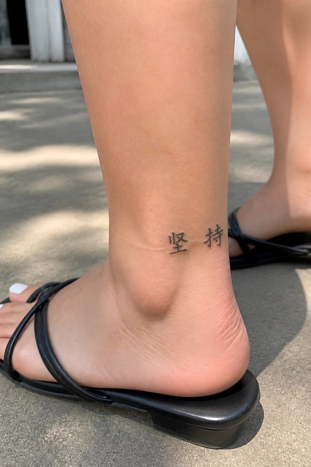 Small Chinese characters tattoo on the inner ankle