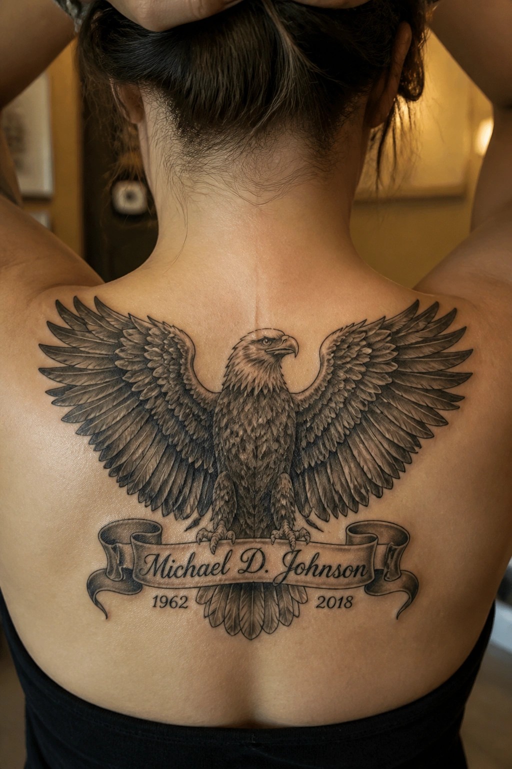 Large eagle tattoo on back with Michael D. Johnson banner and 1962-2018 dates