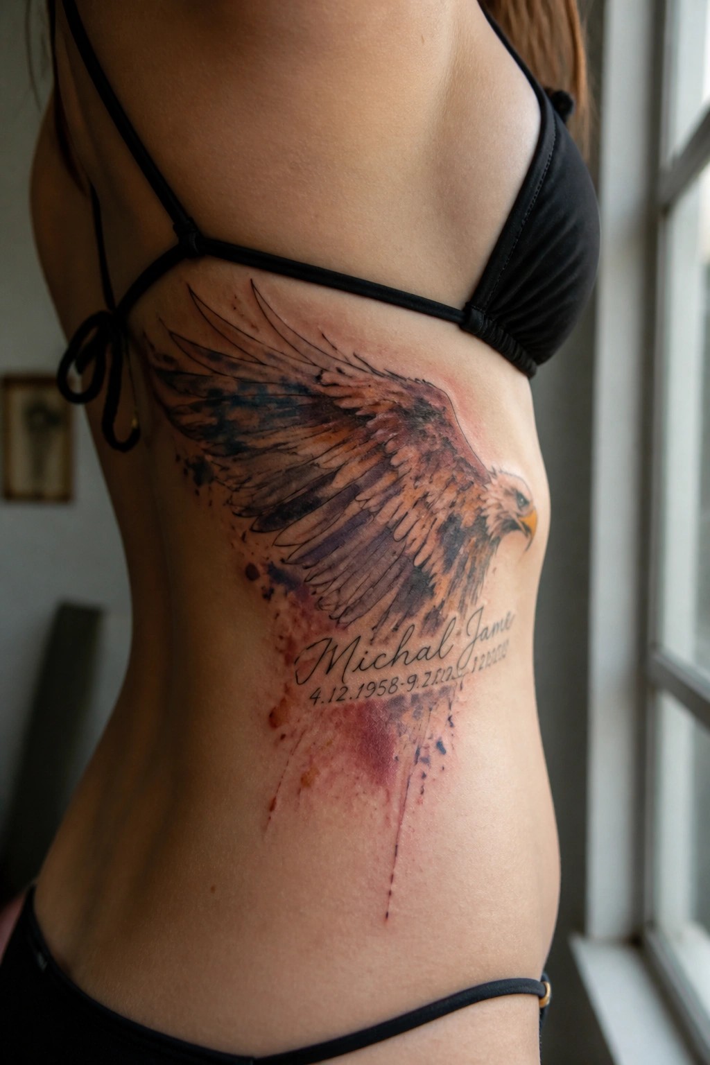 Woman's side with large watercolor eagle tattoo and memorial text below