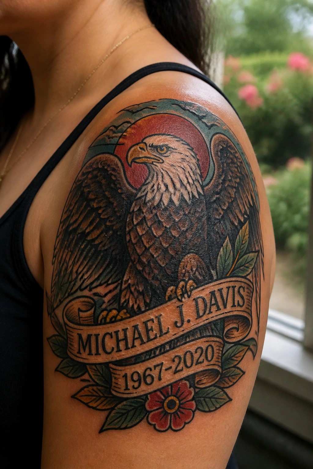 Detailed eagle tattoo on shoulder with name banner, 1967-2020 dates, red sun, and flowers.