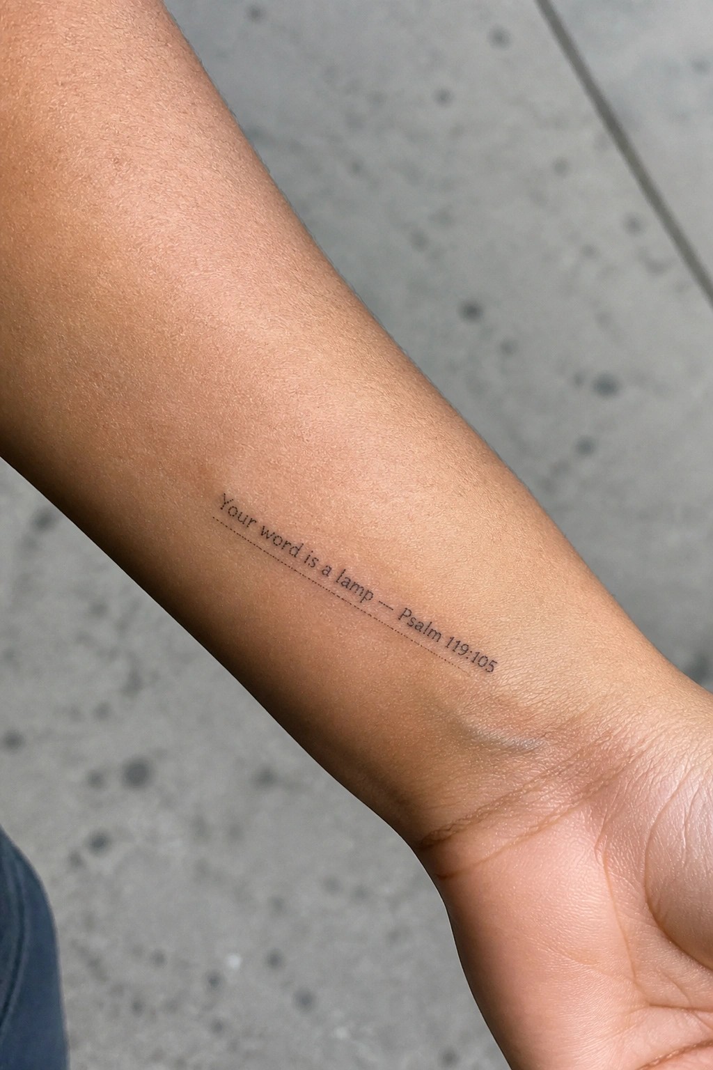 Tattooed forearm with text