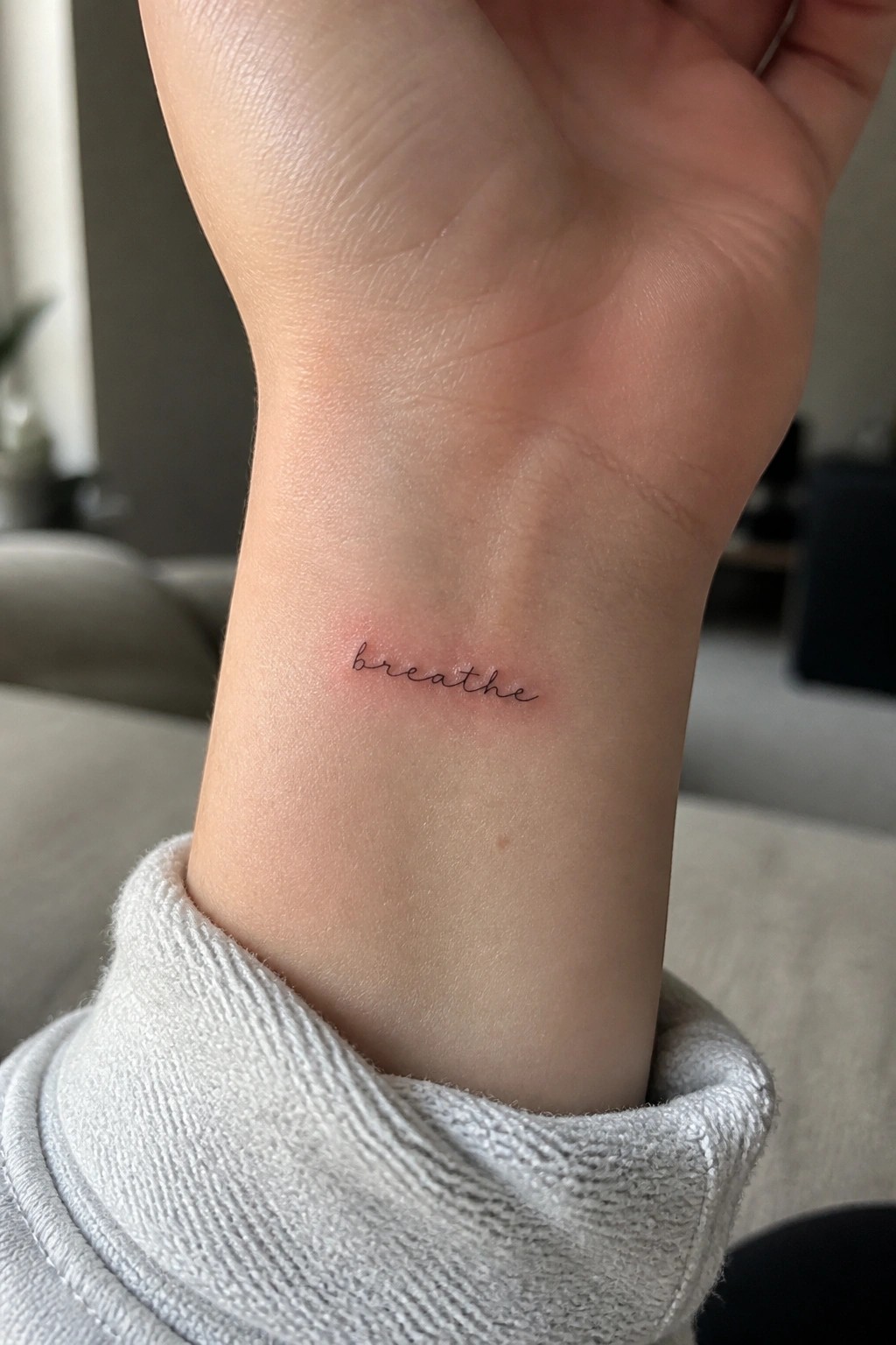 Wrist with black cursive