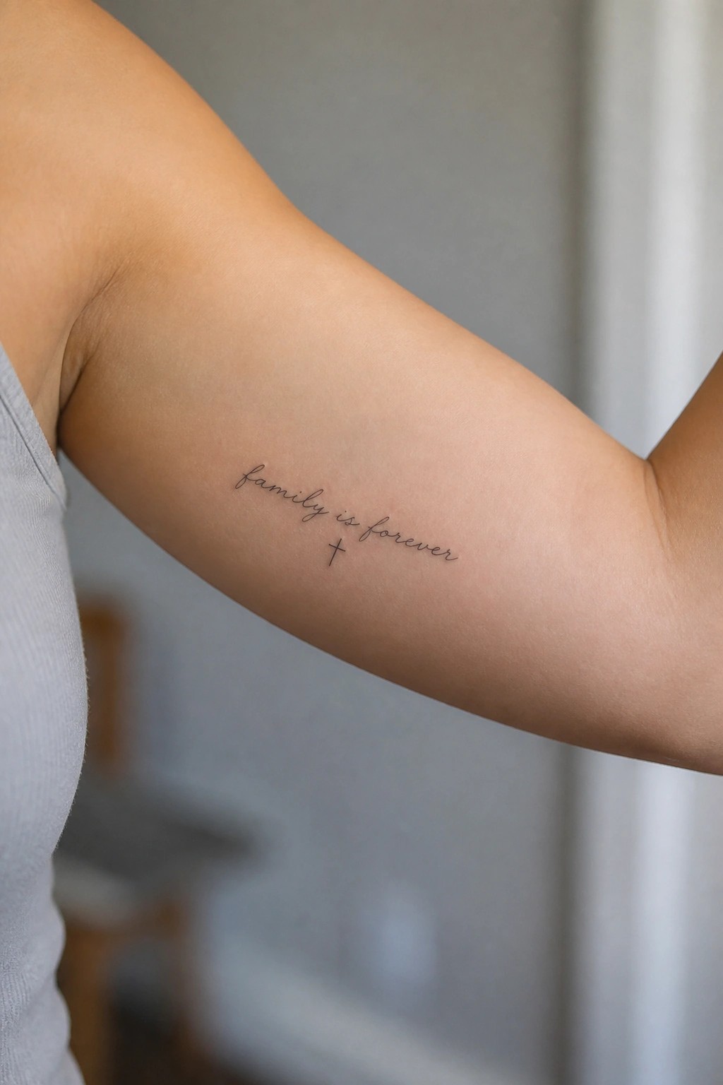 Tattoo on upper arm reading