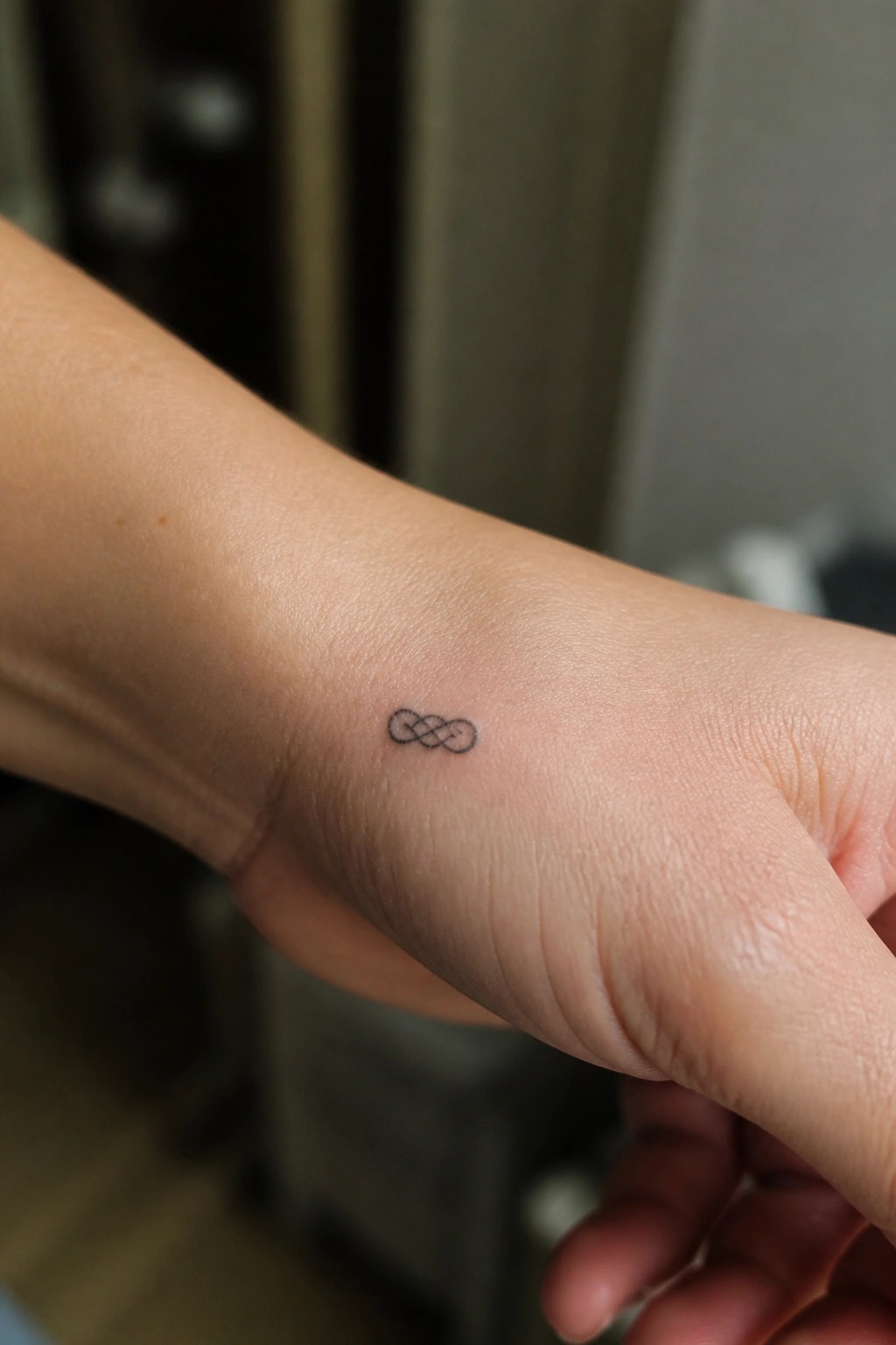 Small infinity symbol tattoo on the inner wrist