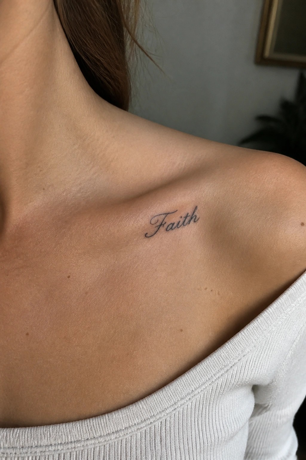 Woman's collarbone with black cursive