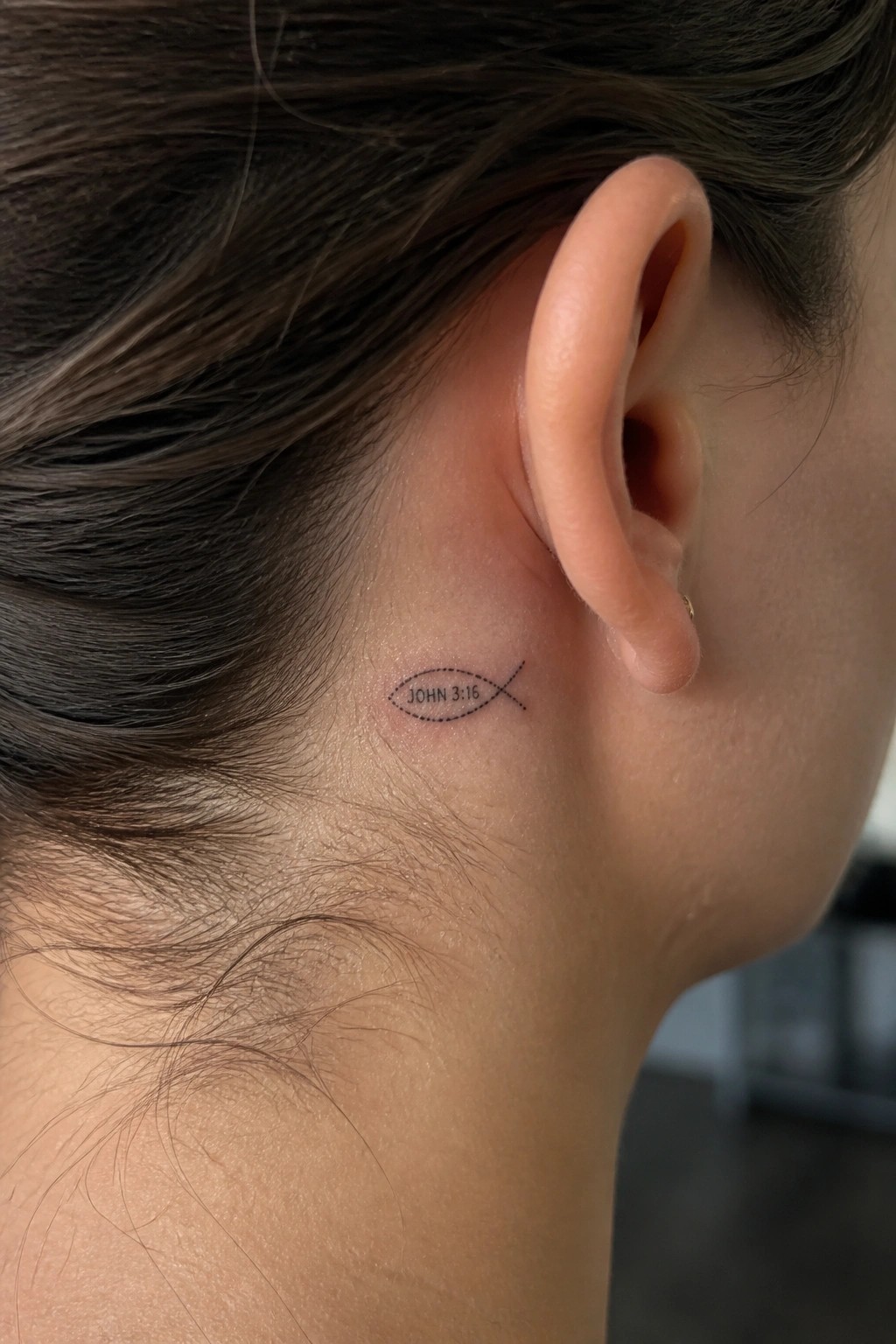 Small black fish tattoo with