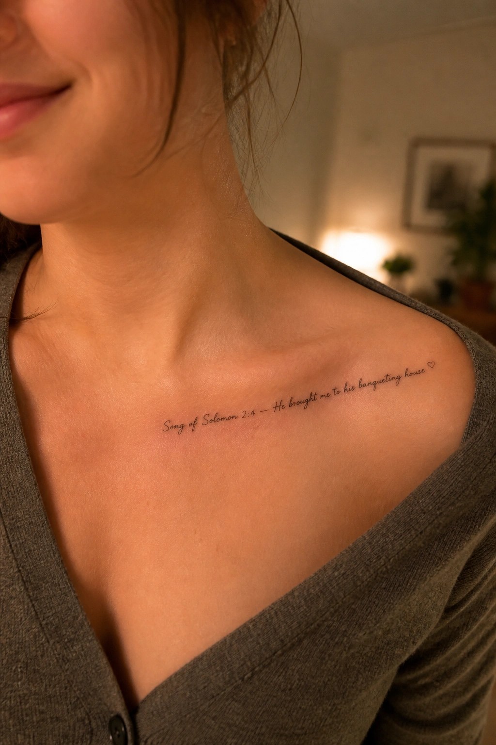 Woman's shoulder shows cursive Song of Solomon 2:4 tattoo in gray top