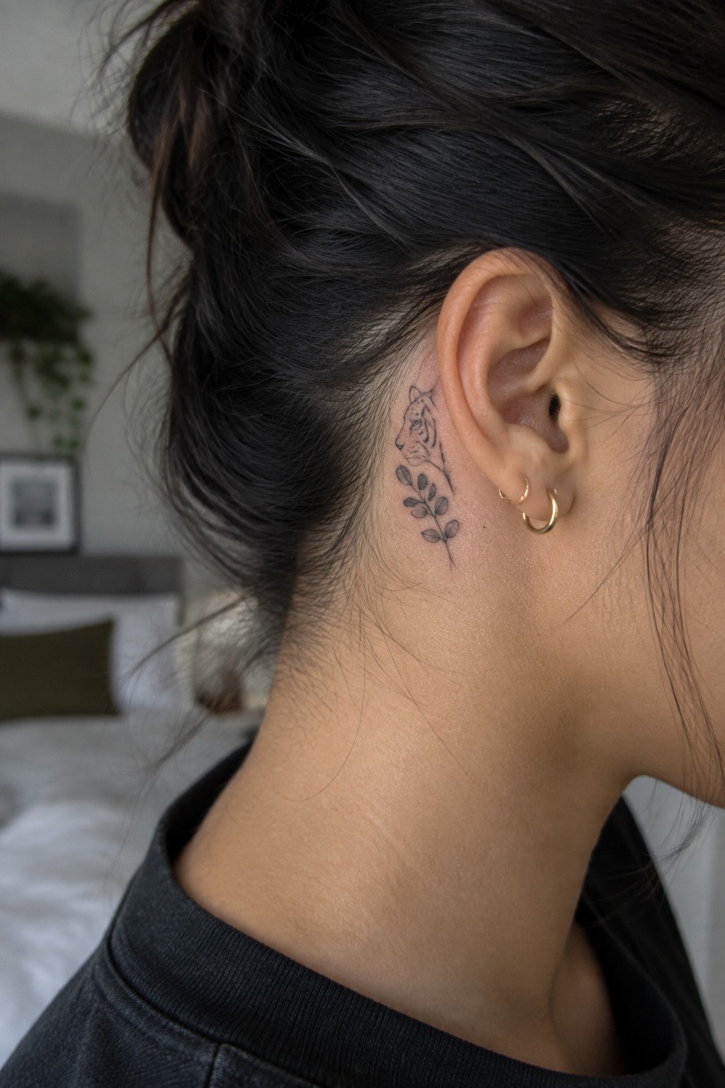 Fine line tiger head with leaves tattooed behind the ear on the side of the neck