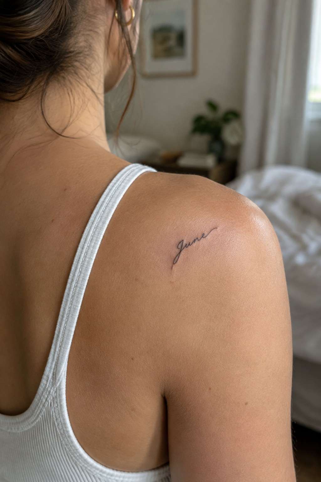 Woman's shoulder with small cursive