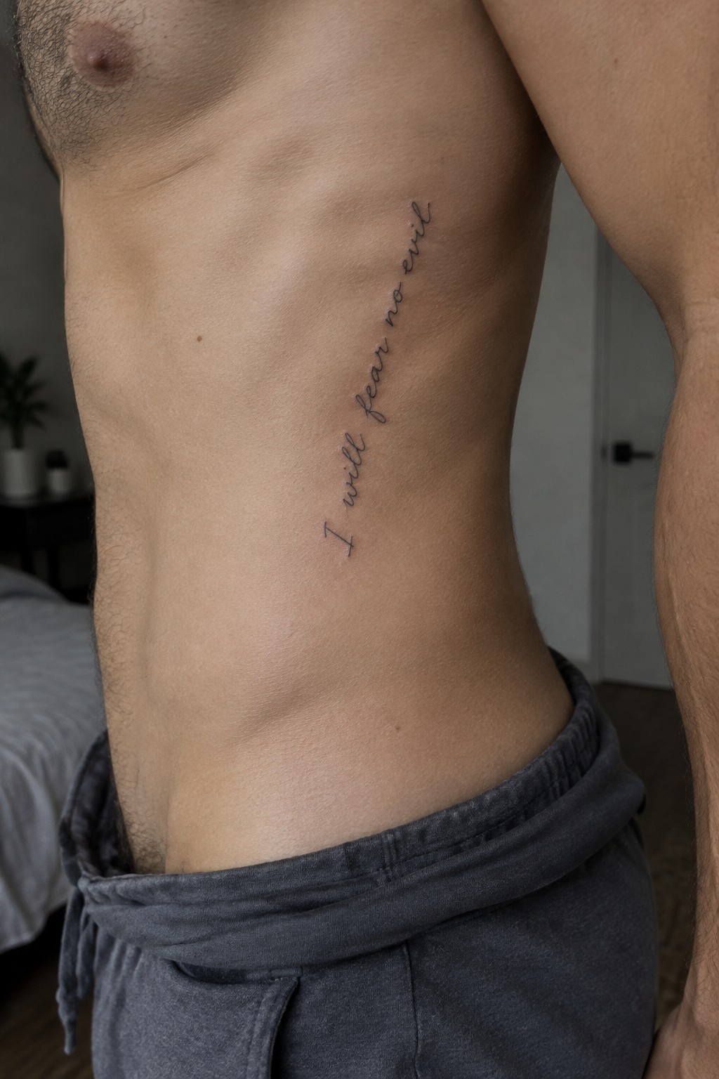 Shirtless torso with cursive 