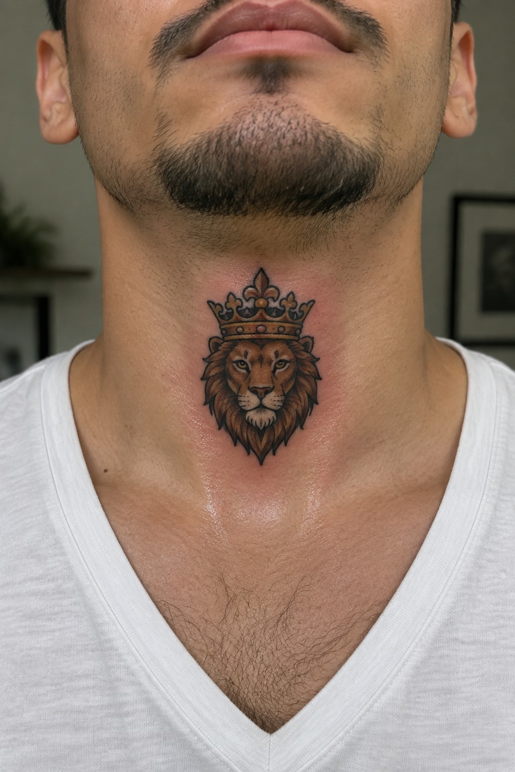 Crowned lion head tattoo on throat of man in white V-neck shirt
