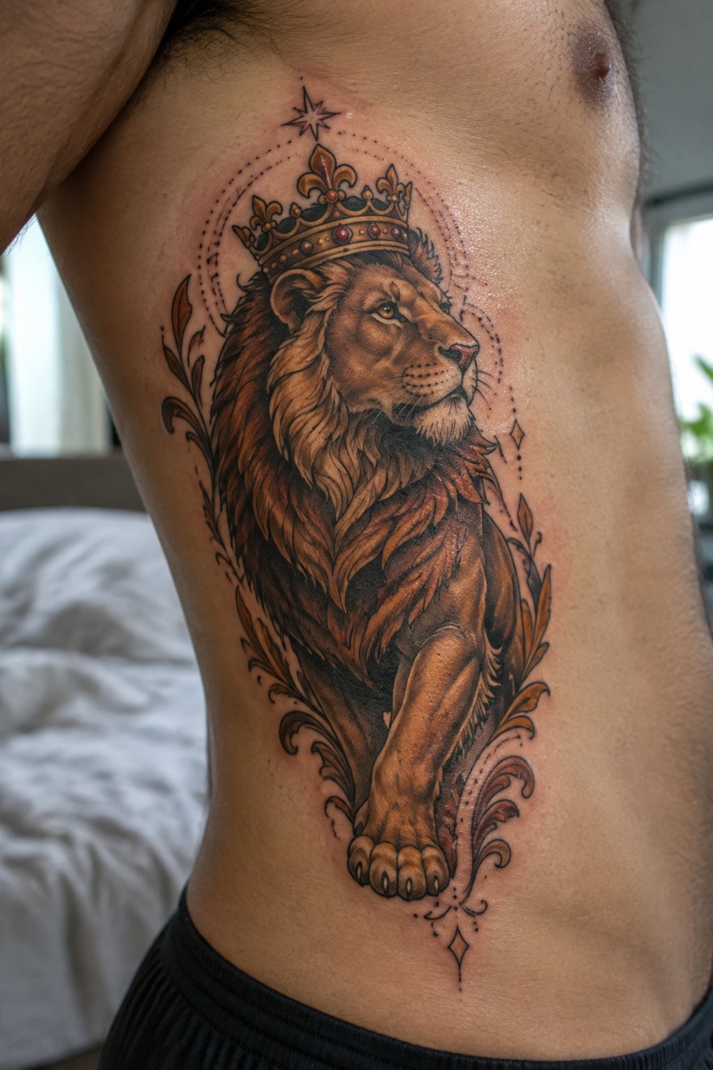 Realistic crowned lion tattoo in brown tones on man's torso with flourishes.