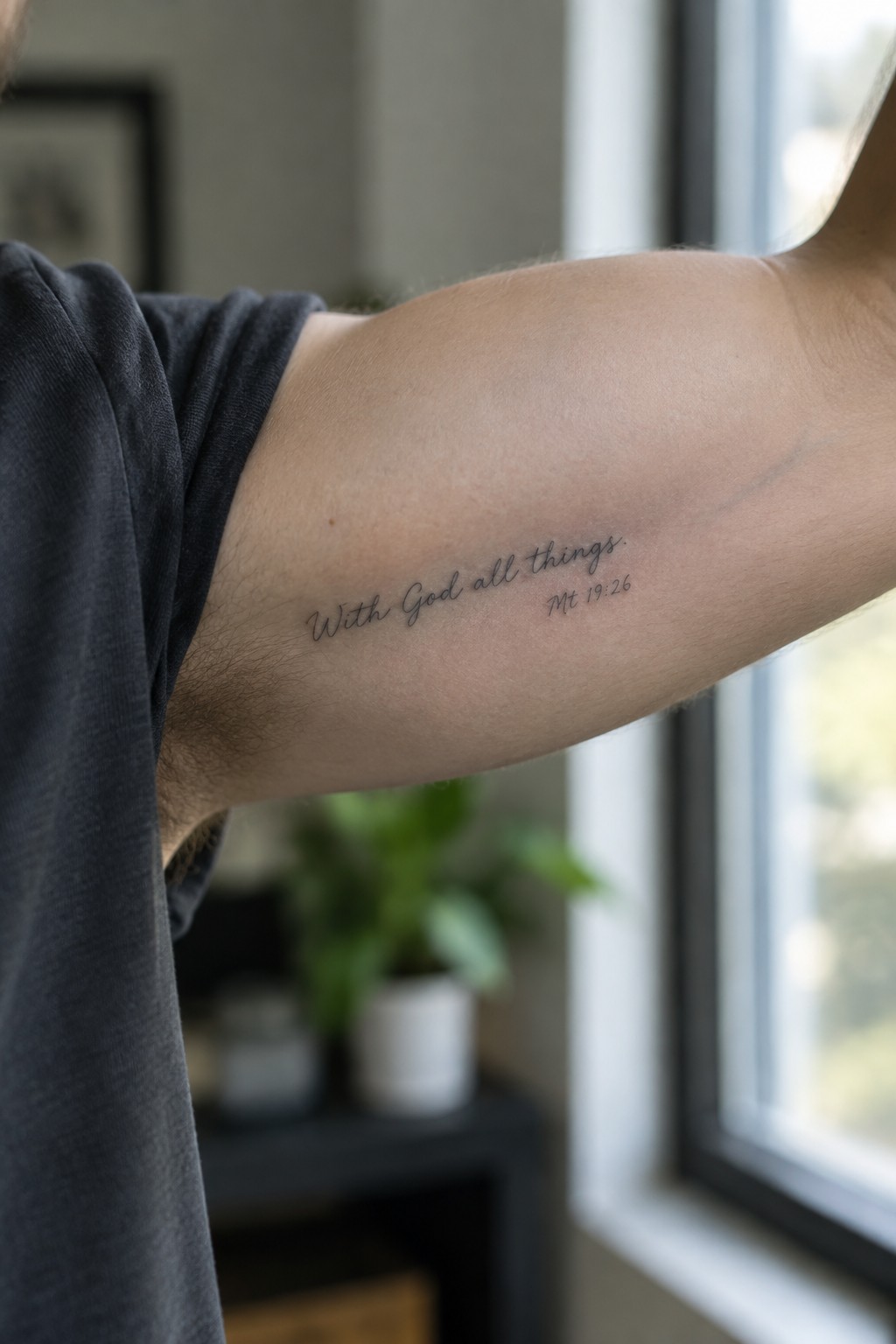 Close up of a small cursive tattoo on a man's inner forearm showing the words 