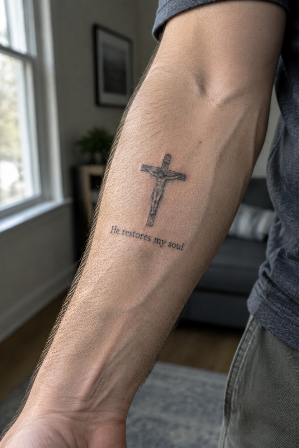 Man's hairy forearm with crucifix tattoo and 