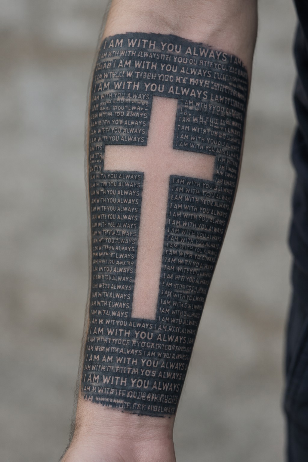 Forearm tattoo with repeated text 
