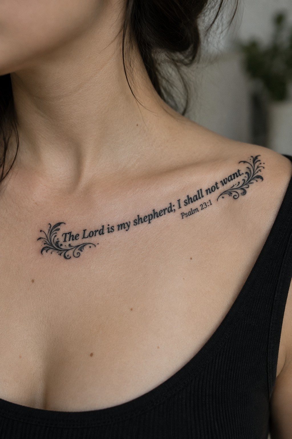 Close up of a blackwork Christian tattoo on a woman's collarbone area with the text