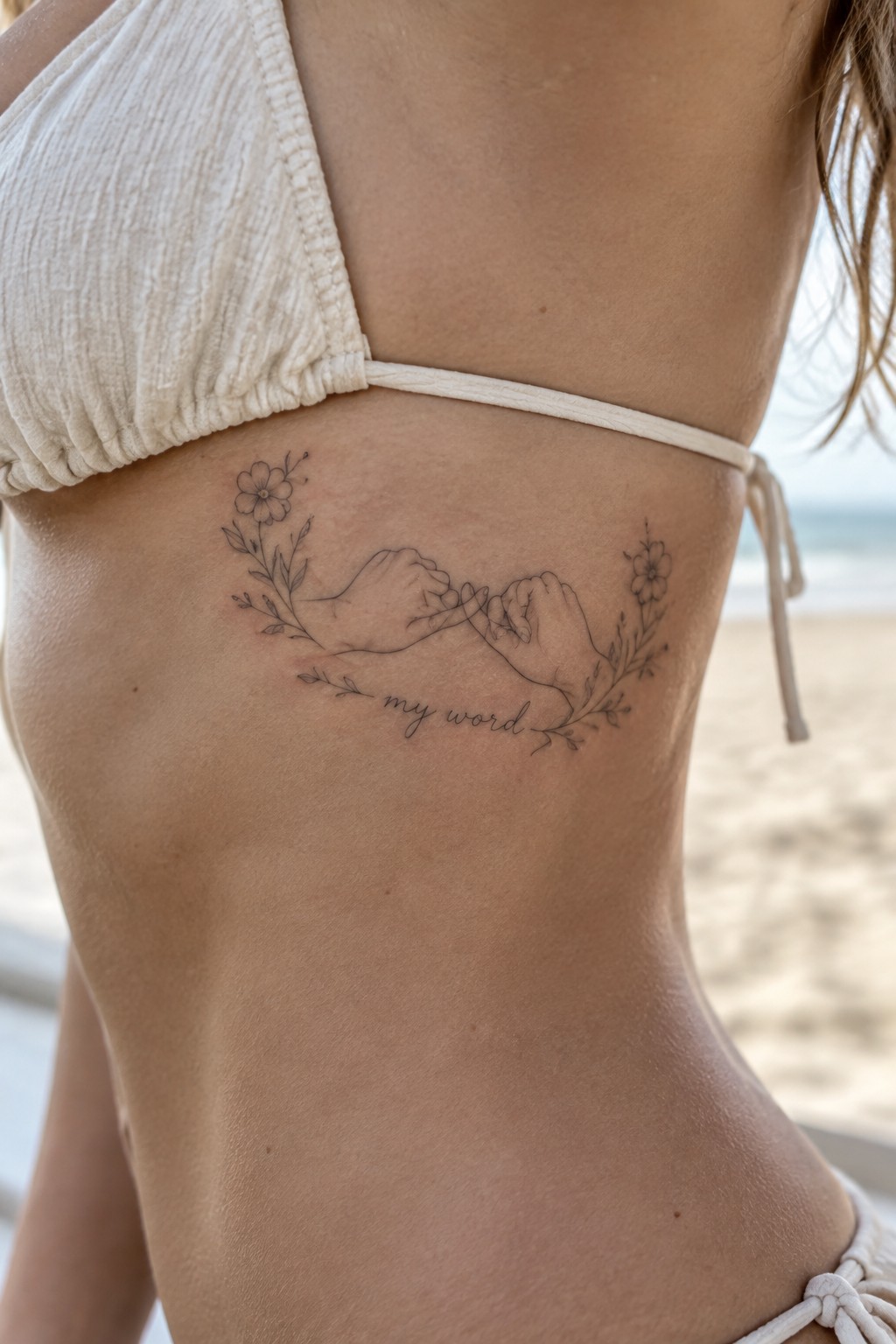 White bikini torso with pinky promise tattoo, floral vines, and 