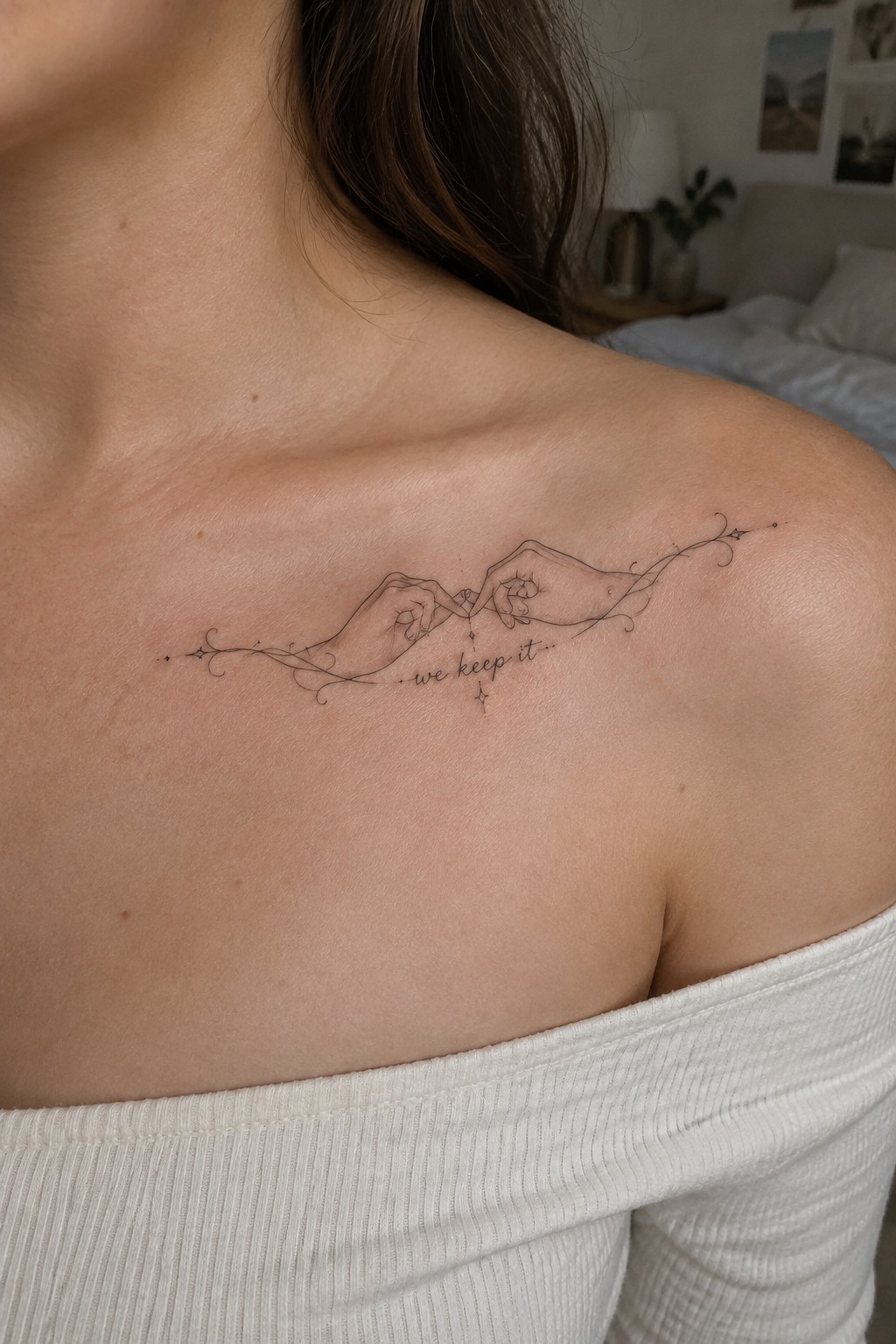 Shoulder tattoo of two hands pinky-promising with vines, stars, and 