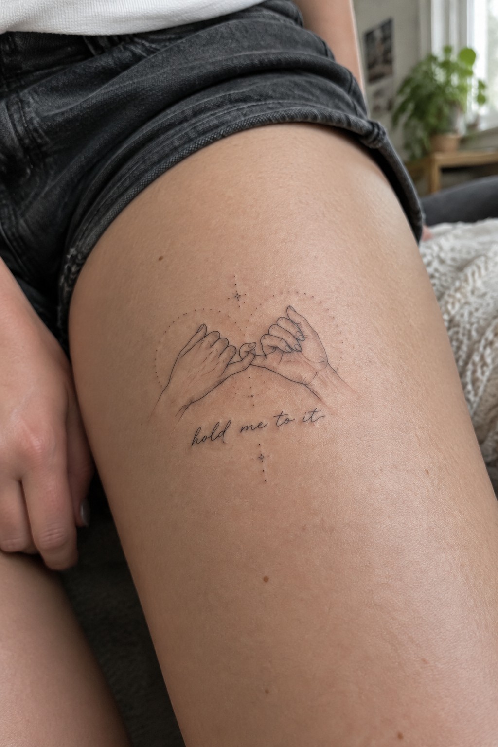 Thigh tattoo of pinky-swearing hands in dotted circle with stars and 