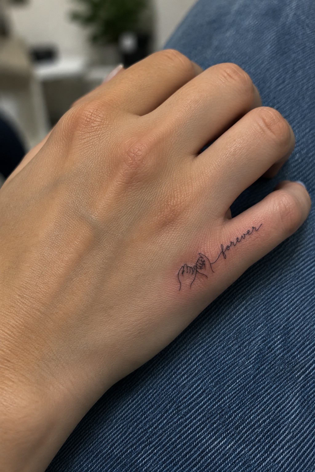 Hand on blue jeans with pinky promise hands and 