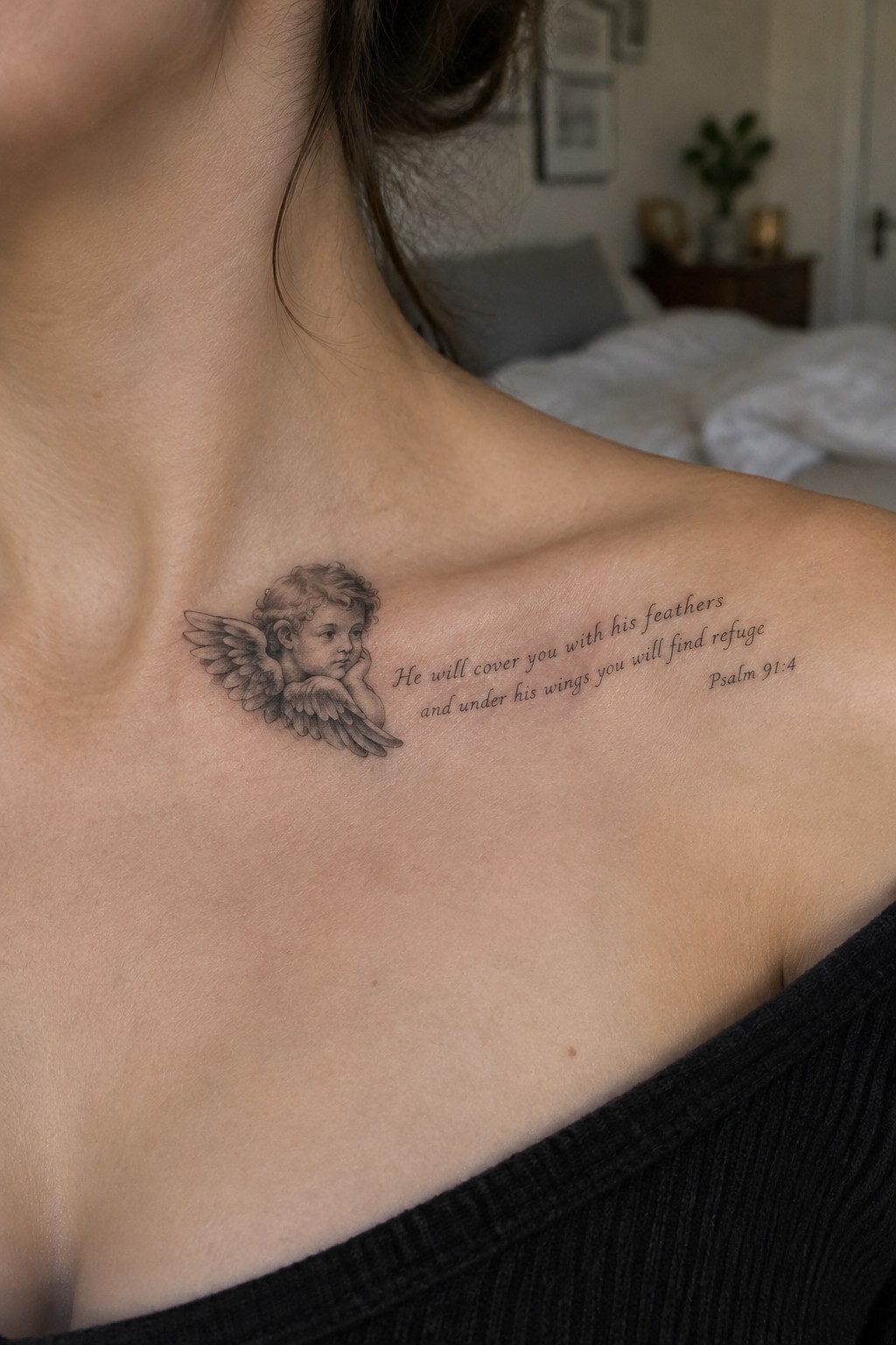 Cherub tattoo with Psalm 91:4 quote on shoulder above black ribbed top