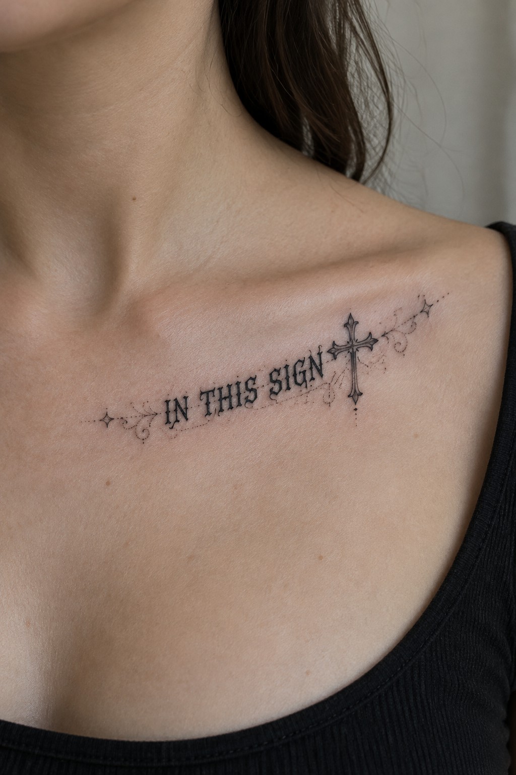 Black tattoo on collarbone reading 