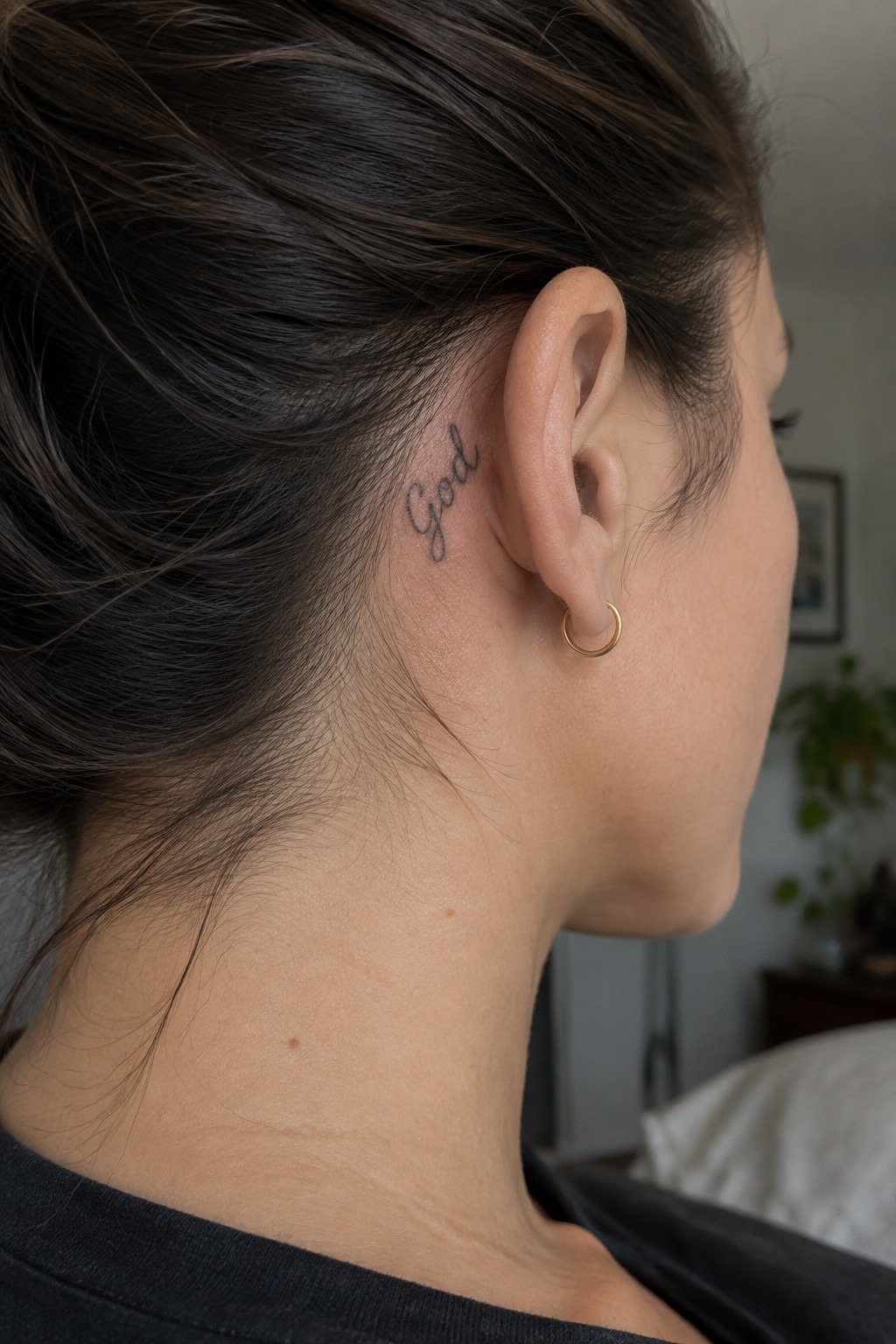 Woman with dark hair in bun,