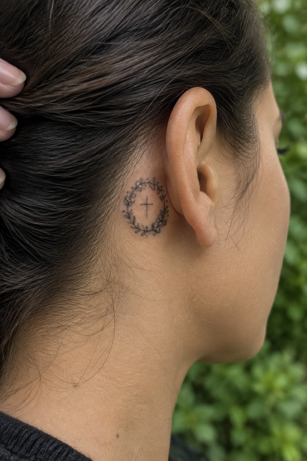 Small floral wreath tattoo with cross behind ear on neck