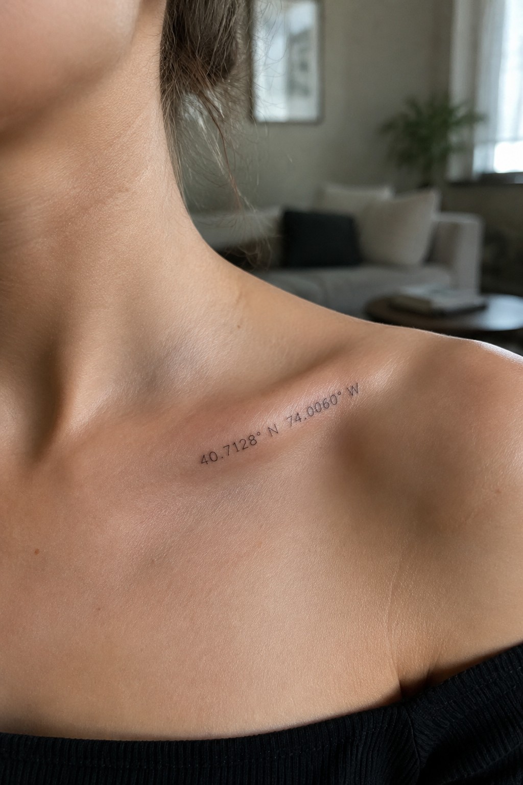 Small coordinates tattoo inked along the collarbone in minimalist script
