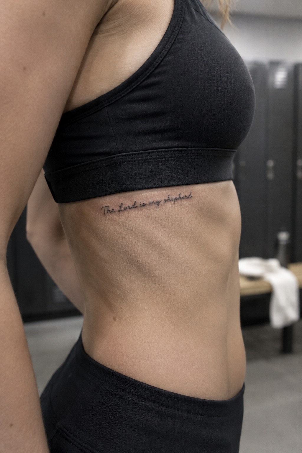 Small cursive tattoo of the words