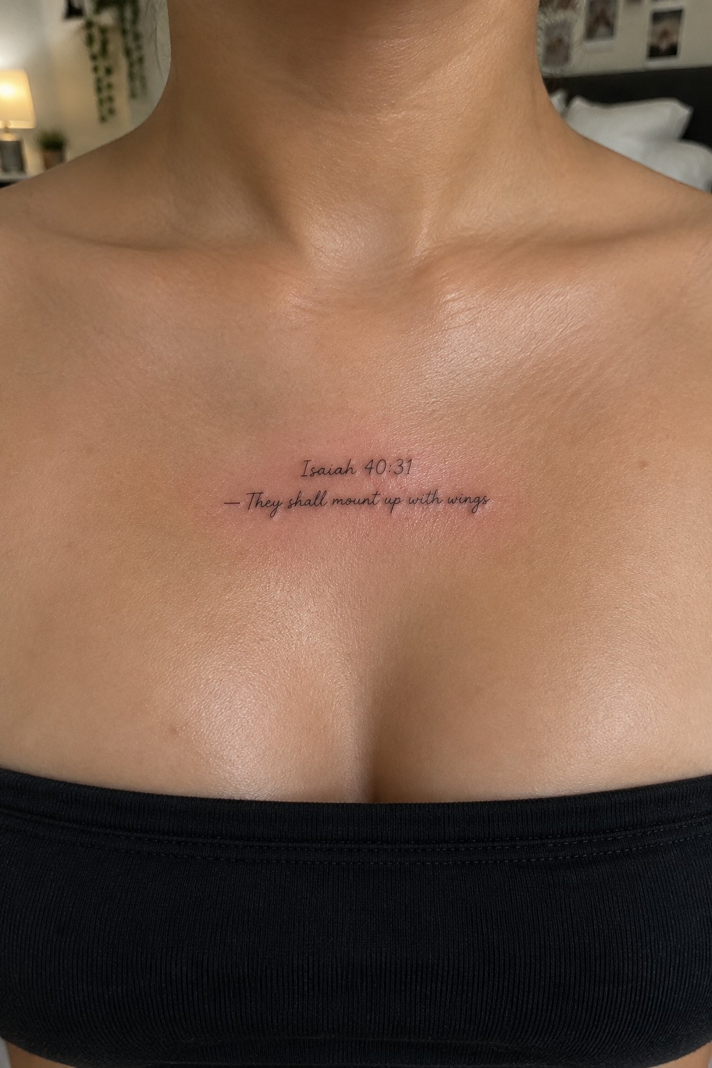 Fine line Isaiah 40:31 tattoo with the words they shall mount up with wings in script on the upper chest.
