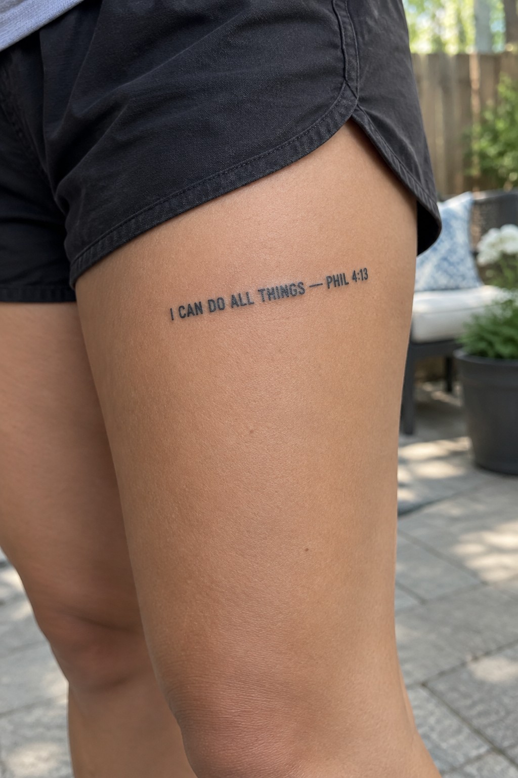 Thigh tattoo reading 