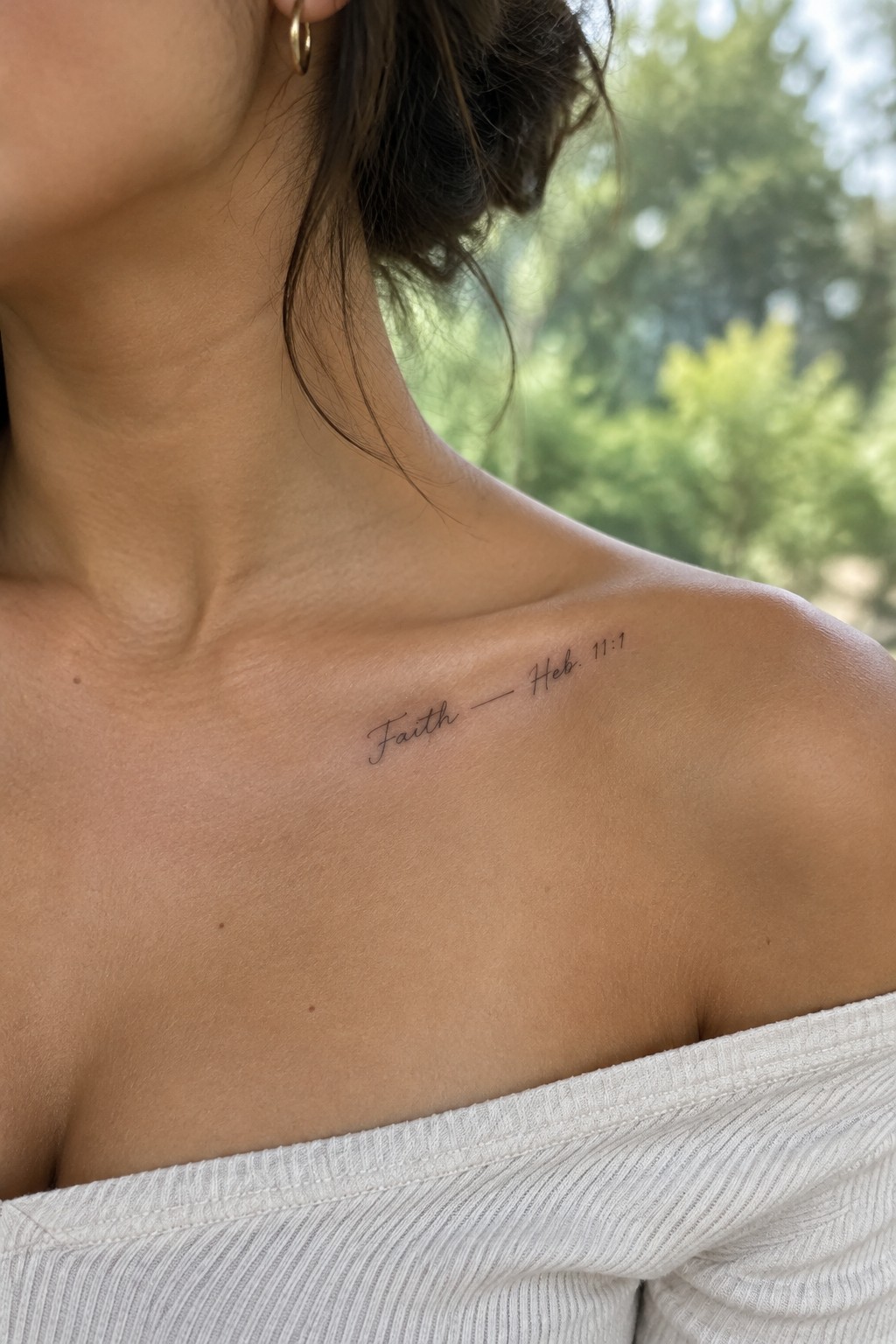 Small fine line tattoo reading faith with hebrews 11 1 reference on a woman's upper chest near the collarbone