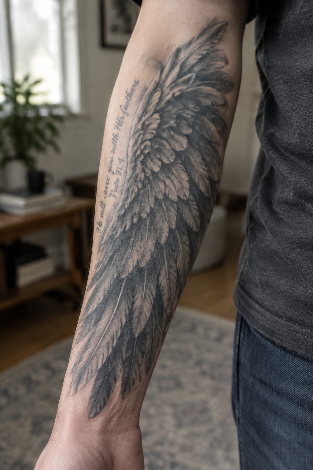 Large detailed feather wing tattoo on forearm with Psalm 91:4 quote text