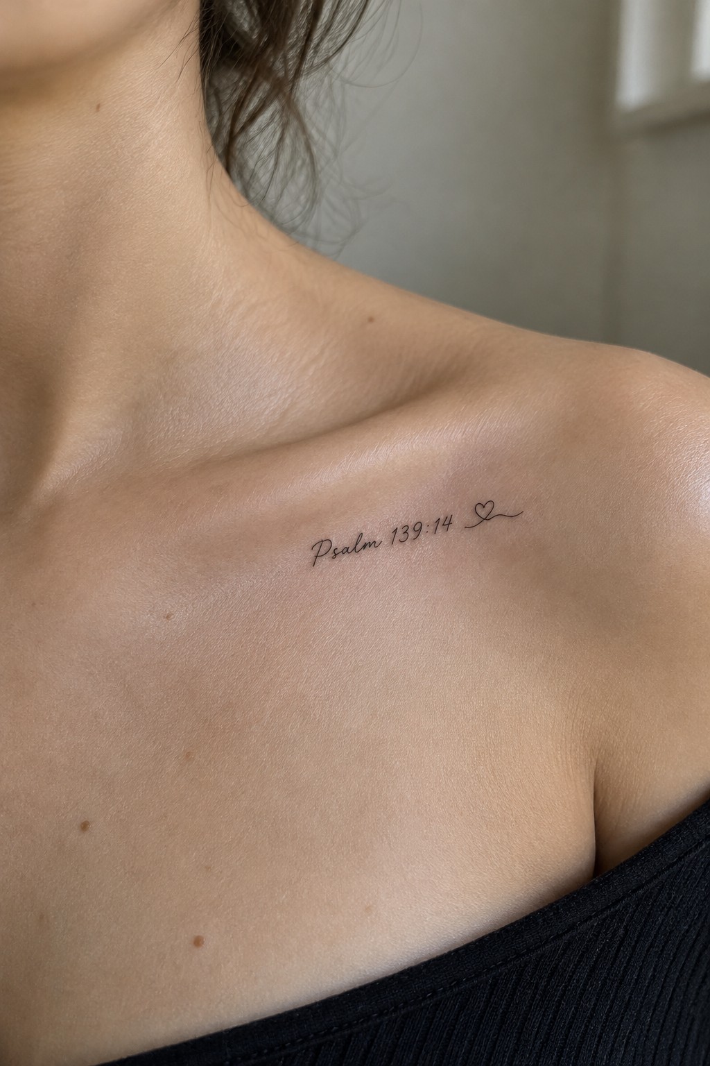 Psalm 139:14 tattoo with heart on light-skinned shoulder above black top