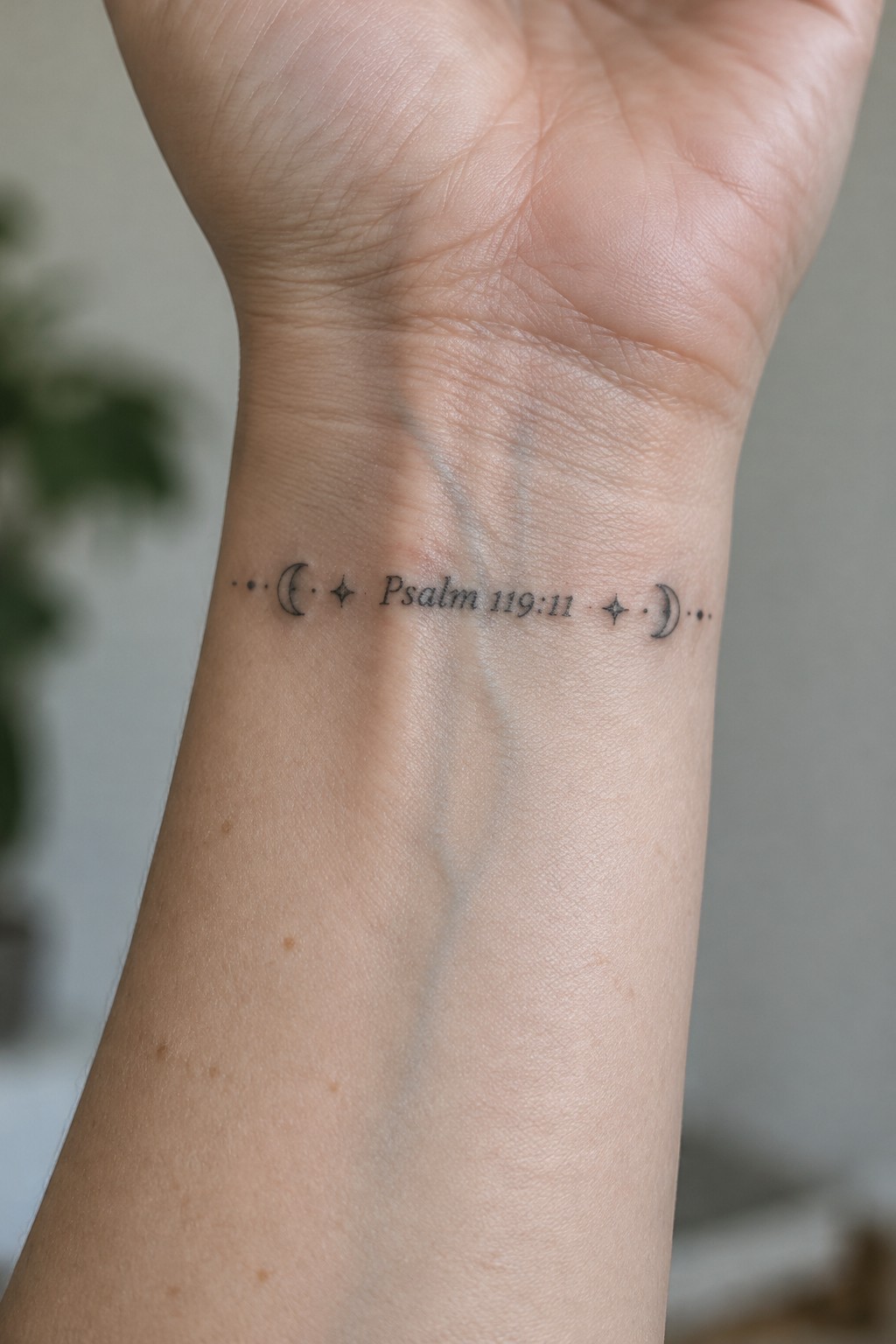 Wrist tattoo reading 
