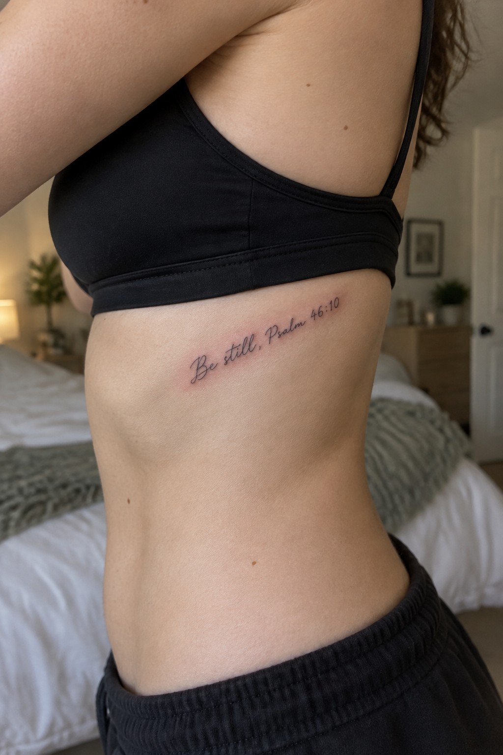 Side view of torso in black bra and pants with 
